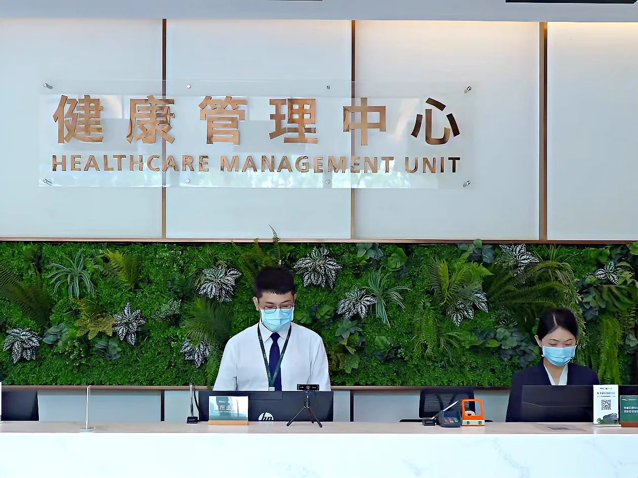A healthcare reception desk with two staff members
